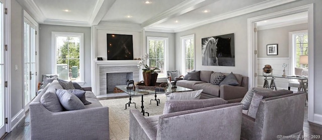 living room with a wealth of natural light, ornamental molding, and dark hardwood / wood-style flooring