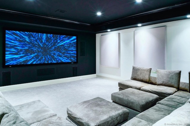 cinema with crown molding and carpet flooring