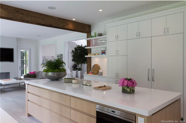 kitchen with light hardwood / wood-style floors, light brown cabinets, white cabinetry, and beamed ceiling