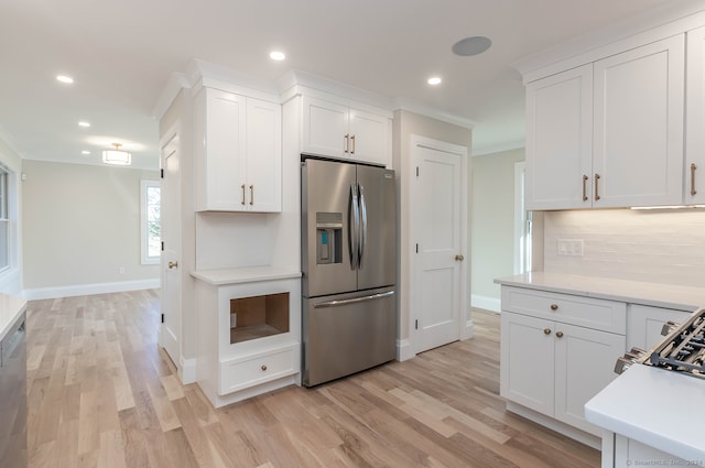 kitchen with white cabinetry, stainless steel refrigerator with ice dispenser, light wood-type flooring, decorative backsplash, and ornamental molding