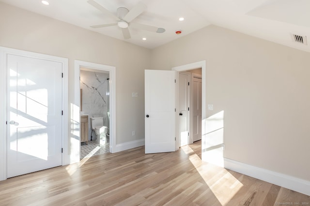 interior space featuring ceiling fan, light wood-type flooring, and lofted ceiling