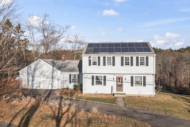 view of front facade featuring a front yard and solar panels