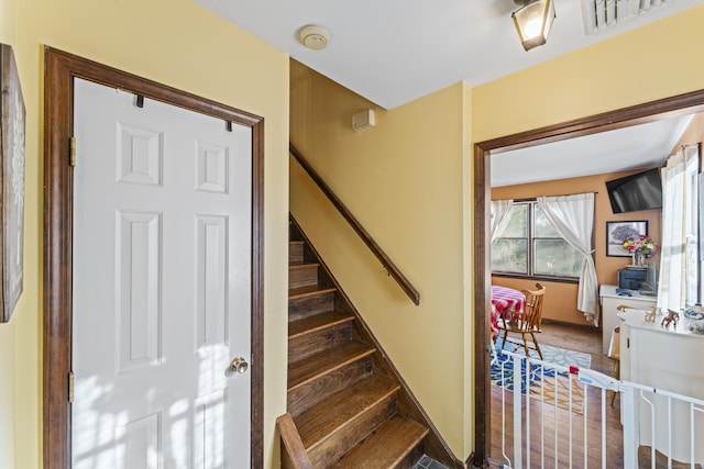 staircase with wood-type flooring