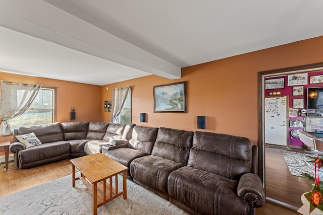 living room featuring beamed ceiling and hardwood / wood-style floors