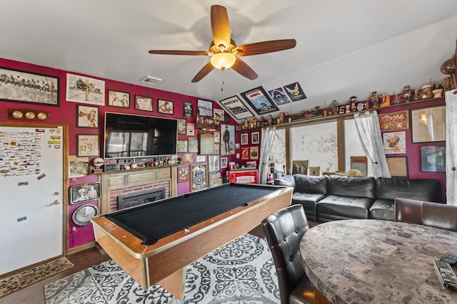 recreation room featuring ceiling fan, hardwood / wood-style floors, lofted ceiling, a fireplace, and pool table