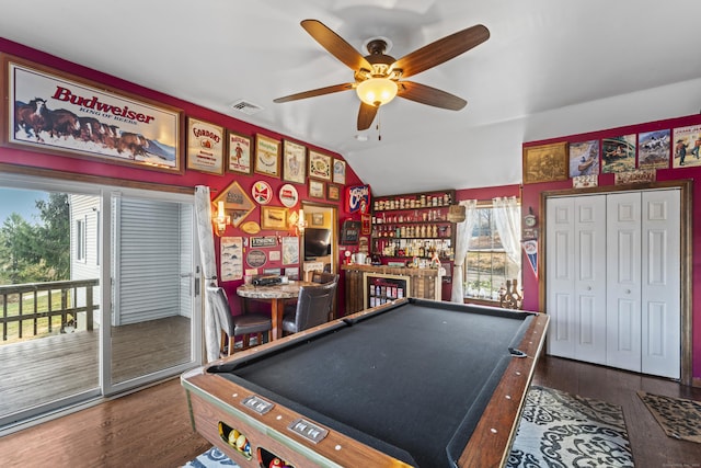 rec room featuring dark hardwood / wood-style floors, vaulted ceiling, and a healthy amount of sunlight