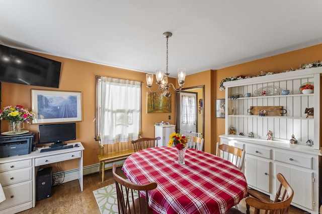 dining room featuring baseboard heating, dark wood-type flooring, and a notable chandelier