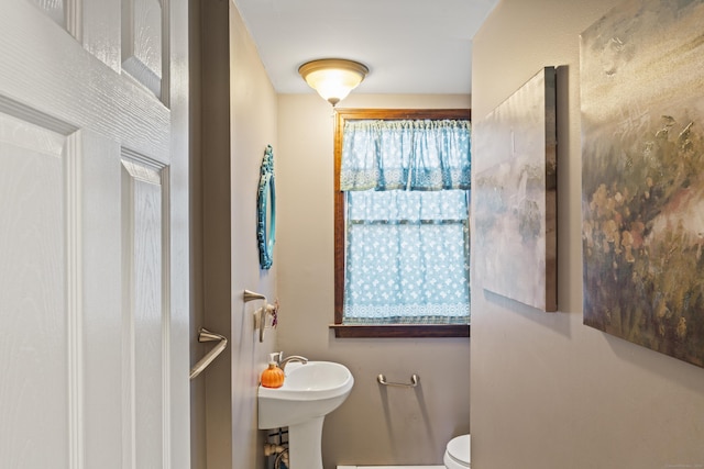 bathroom featuring toilet and sink