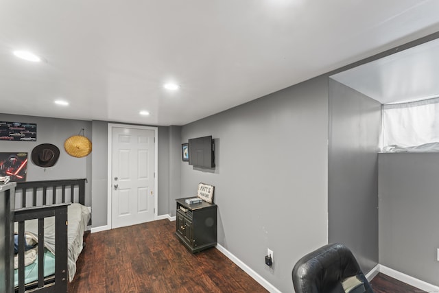 bedroom with dark wood-type flooring