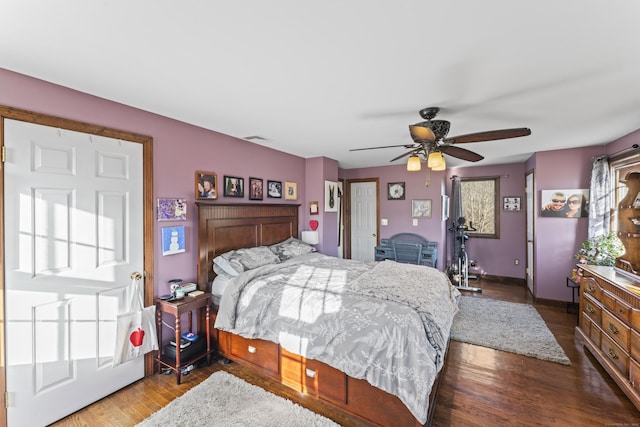 bedroom featuring hardwood / wood-style flooring, multiple windows, and ceiling fan