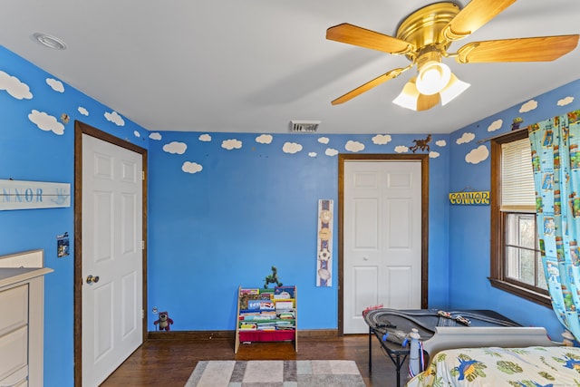 bedroom with ceiling fan and dark hardwood / wood-style flooring