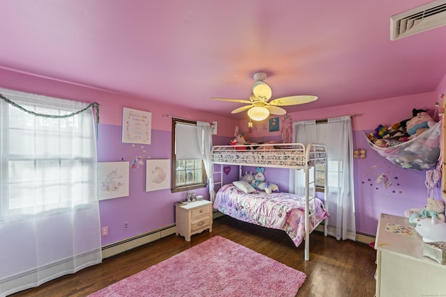 bedroom featuring dark hardwood / wood-style floors, ceiling fan, and a baseboard heating unit