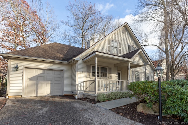 view of front of property featuring covered porch and a garage