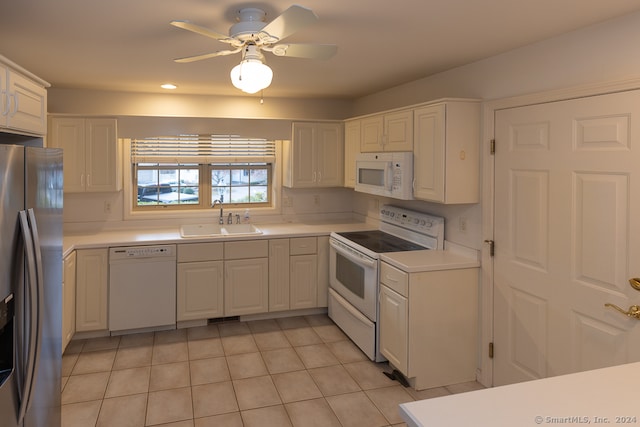 kitchen featuring white appliances, white cabinetry, ceiling fan, and sink