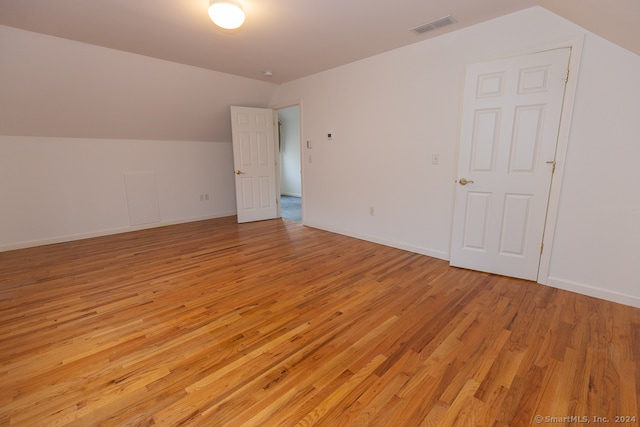 bonus room featuring light hardwood / wood-style flooring and vaulted ceiling