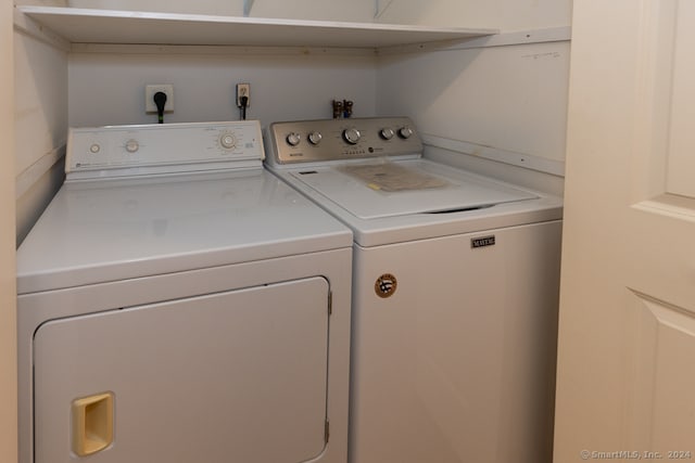 clothes washing area featuring independent washer and dryer