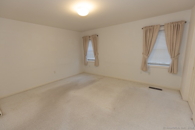 empty room featuring light colored carpet