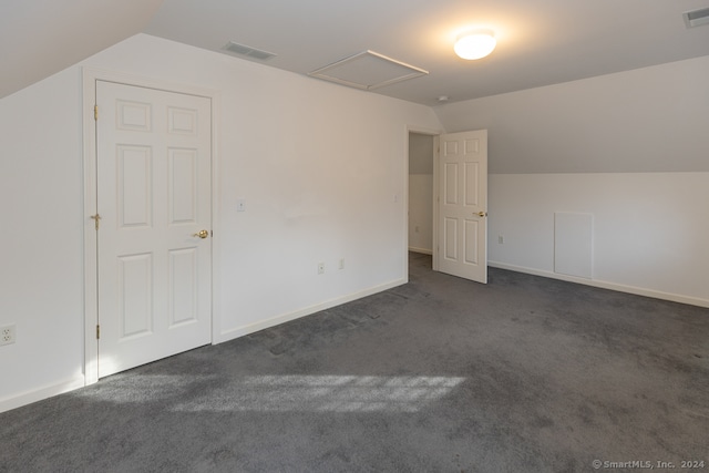 bonus room featuring dark colored carpet and vaulted ceiling