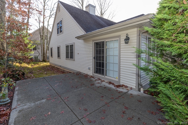 view of side of home with a patio area