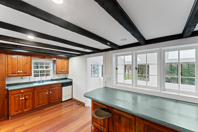 kitchen featuring light wood-type flooring, sink, white dishwasher, and beam ceiling