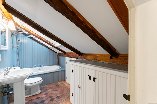 bathroom with tile patterned flooring, a bathing tub, vaulted ceiling with beams, and toilet