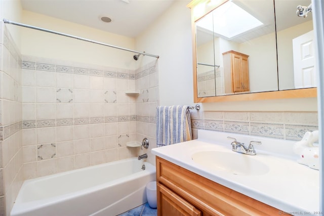 bathroom featuring vanity, decorative backsplash, and tiled shower / bath combo