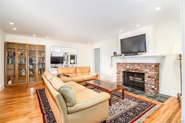 living room featuring wood-type flooring and a fireplace