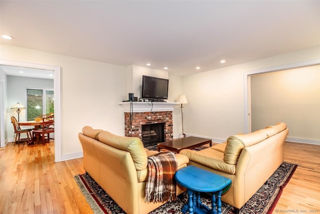 living room featuring light hardwood / wood-style floors and a fireplace