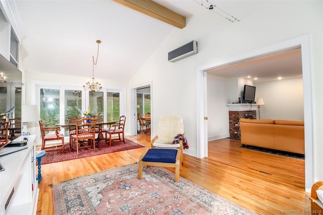 interior space with beam ceiling, an AC wall unit, hardwood / wood-style floors, a brick fireplace, and an inviting chandelier