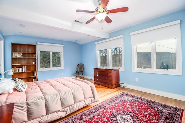 bedroom featuring ceiling fan, lofted ceiling, a baseboard radiator, and light hardwood / wood-style floors