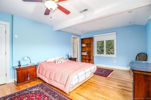 bedroom featuring light hardwood / wood-style floors, lofted ceiling with beams, and ceiling fan