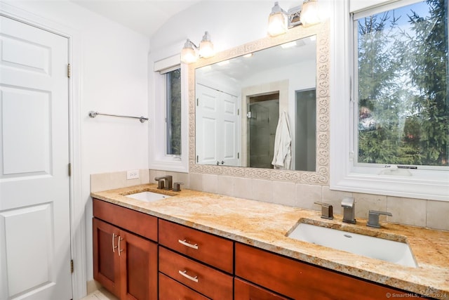 bathroom with vanity and decorative backsplash