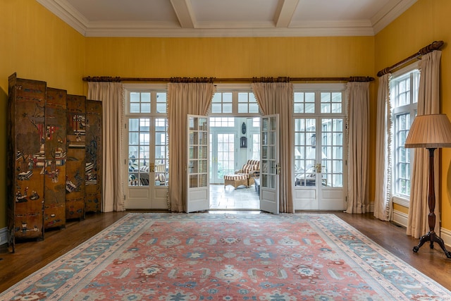 entryway with beam ceiling, wood finished floors, and french doors