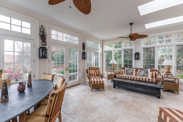 sunroom / solarium with a skylight, french doors, and ceiling fan