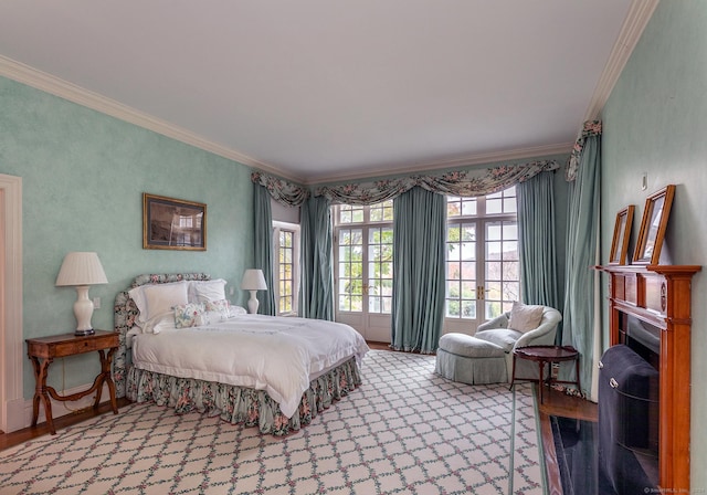 bedroom featuring ornamental molding, a fireplace, wood finished floors, and baseboards