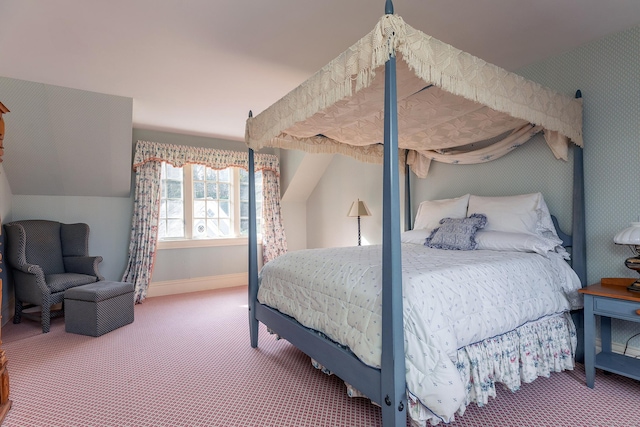 carpeted bedroom featuring vaulted ceiling and baseboards