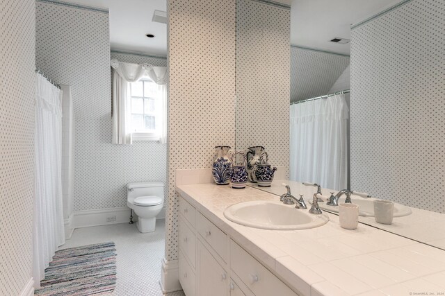 full bath with tile patterned flooring, toilet, vanity, baseboards, and wallpapered walls