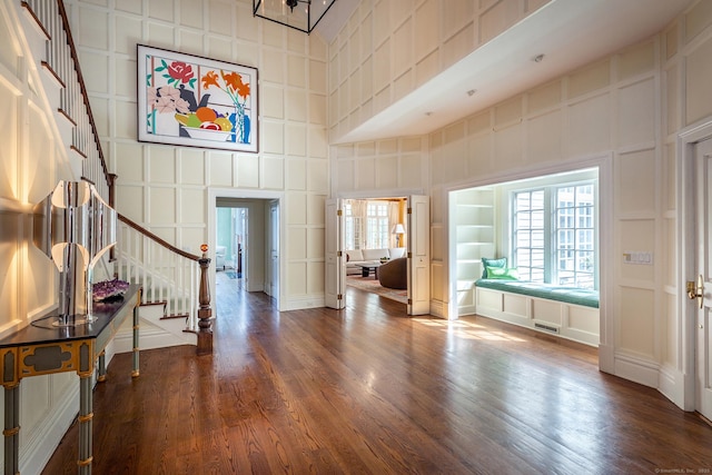 11 Ravenrock Rd, Roxbury, CT 06783 - foyer entrance with a decorative wall, stairway, wood finished floors, and a high ceiling