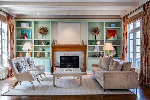 11 Ravenrock Rd, Roxbury, CT 06783 - living area with wood finished floors, beam ceiling, built in shelves, and a fireplace