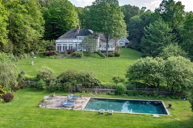11 Ravenrock Rd, Roxbury, CT 06783 - rear view of property with a patio, a chimney, and a view of trees