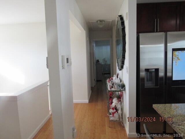 hallway with baseboards and light wood-style floors