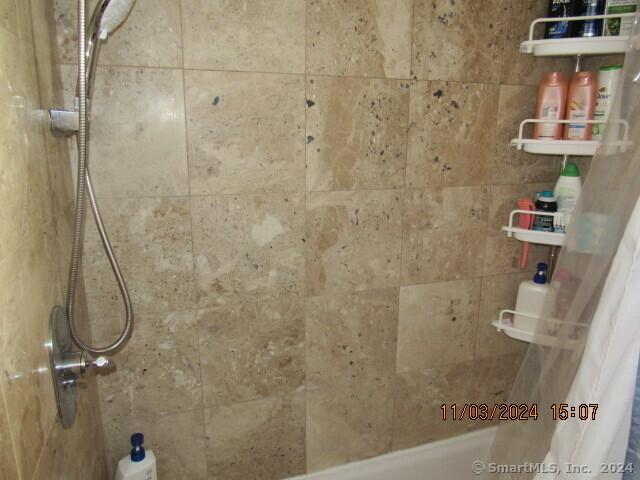 full bath featuring shower / bath combination with curtain