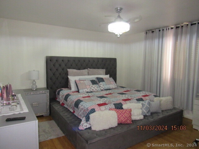 bedroom featuring ceiling fan and hardwood / wood-style floors