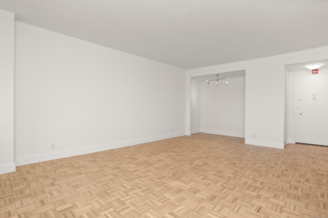 unfurnished room with light parquet flooring