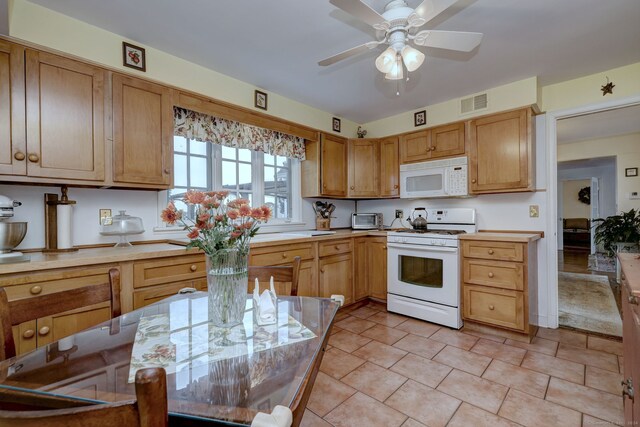 kitchen with ceiling fan, light tile patterned floors, and white appliances