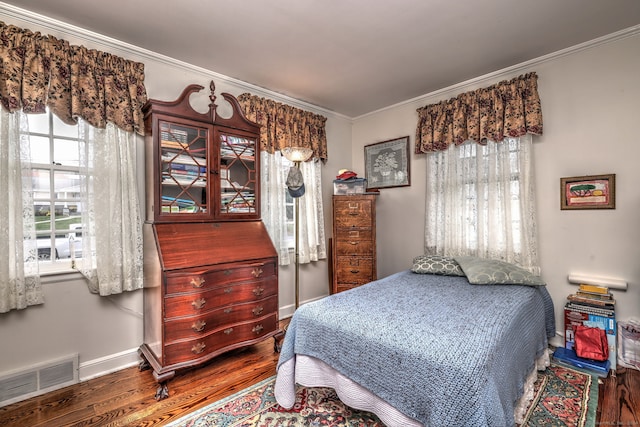 bedroom featuring crown molding and hardwood / wood-style flooring