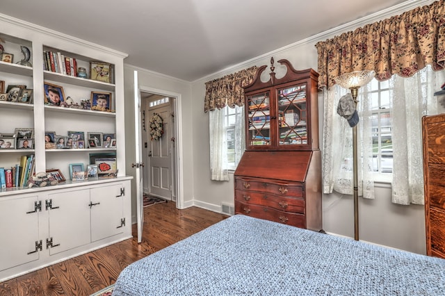 bedroom featuring crown molding and dark hardwood / wood-style floors