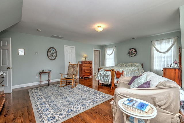 bedroom with dark hardwood / wood-style floors