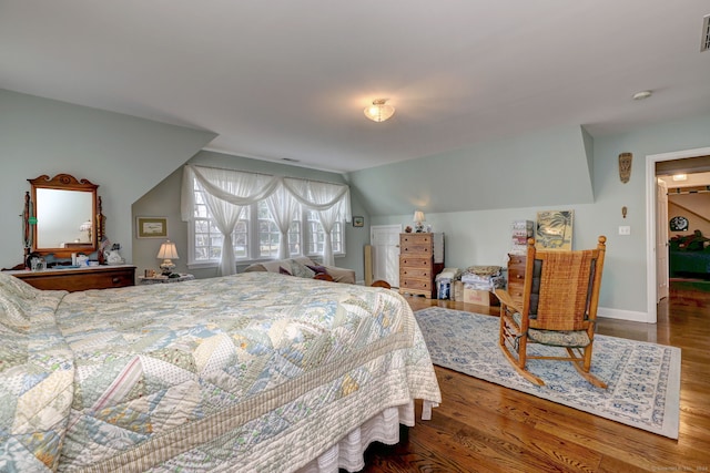 bedroom featuring wood-type flooring and vaulted ceiling