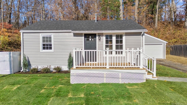 view of front of house featuring a garage, a front yard, and a deck